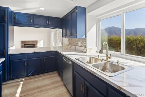 a kitchen with a sink and a refrigerator