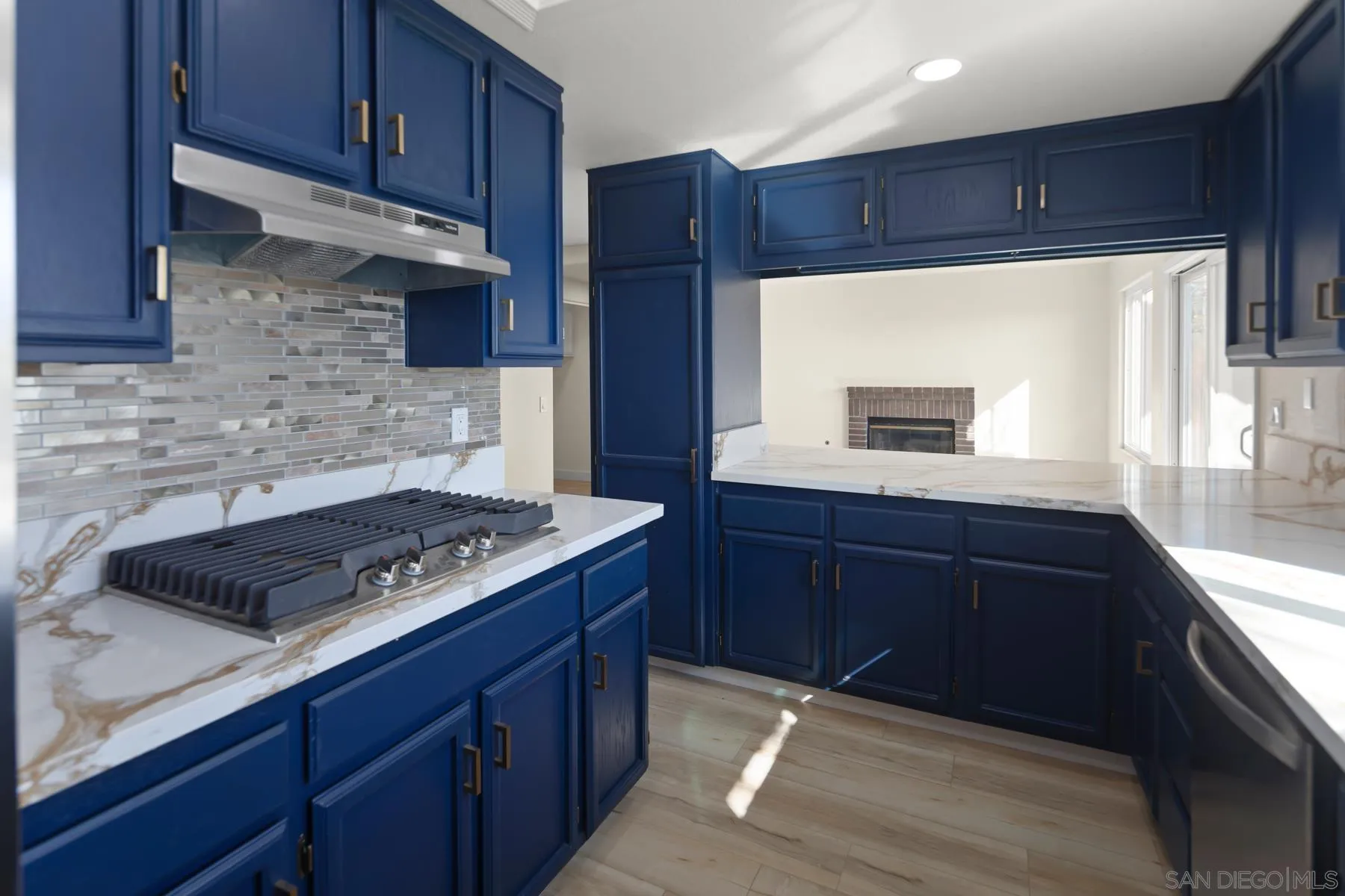 10167 Bluestone Court Spring Valley, CA 91977 - Photo 14 of 49 a kitchen with wooden cabinets and a stove top oven