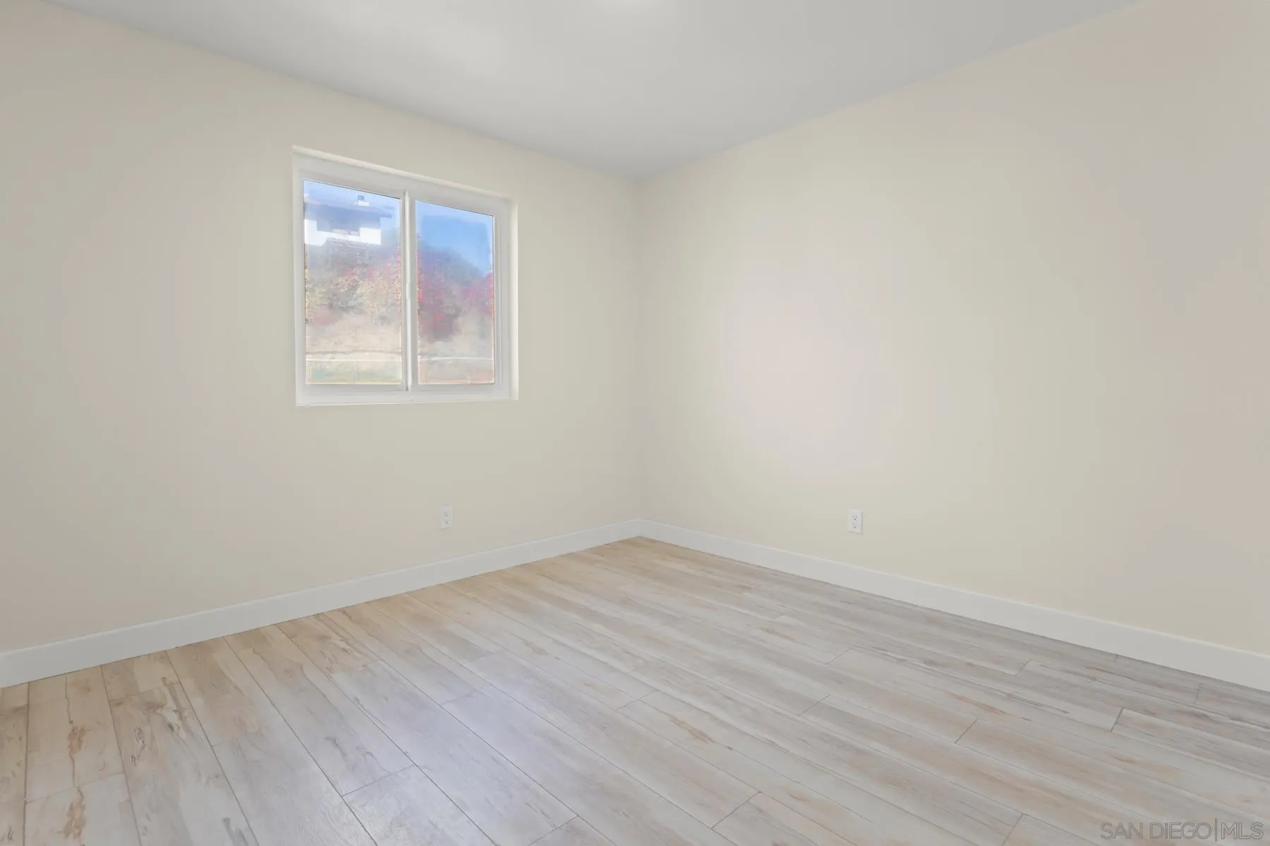 10167 Bluestone Court Spring Valley, CA 91977 - Photo 18 of 49 an empty room with wooden floor and windows