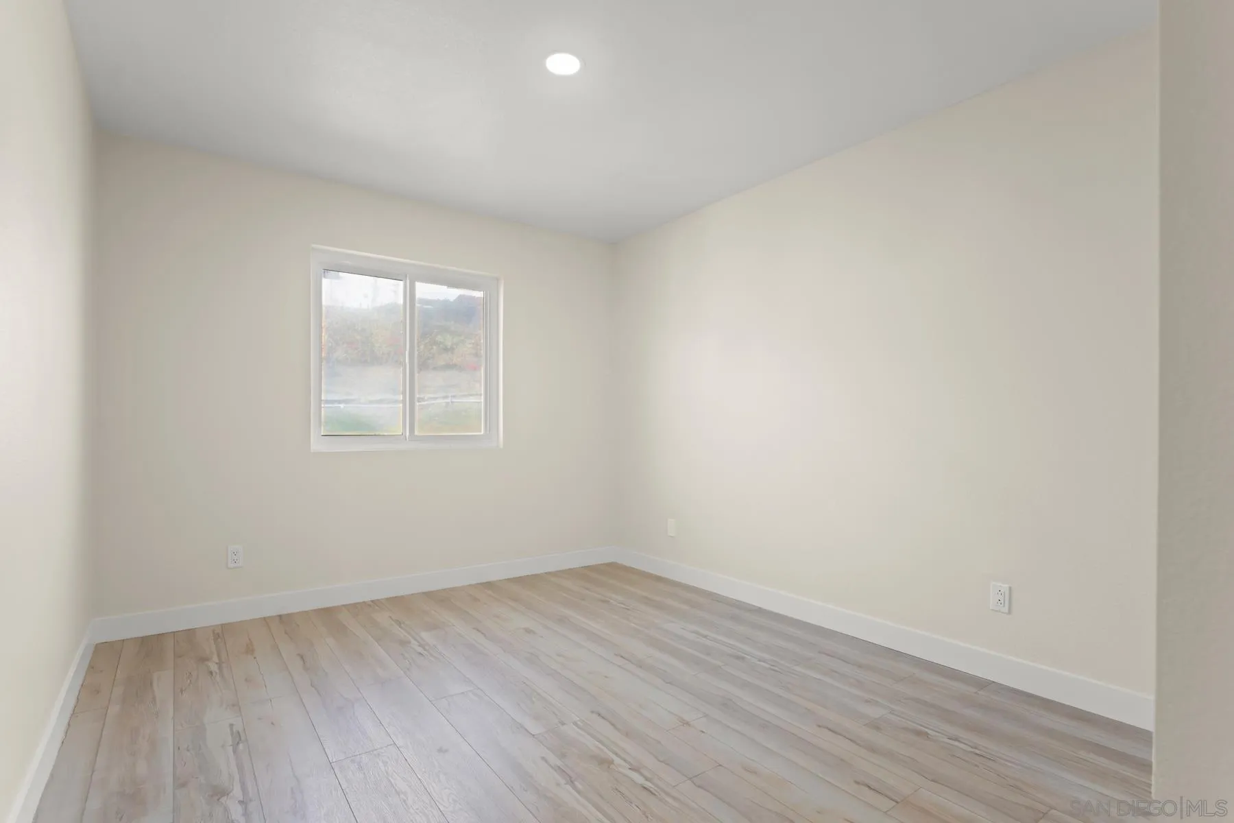 10167 Bluestone Court Spring Valley, CA 91977 - Photo 20 of 49 an empty room with wooden floor and windows