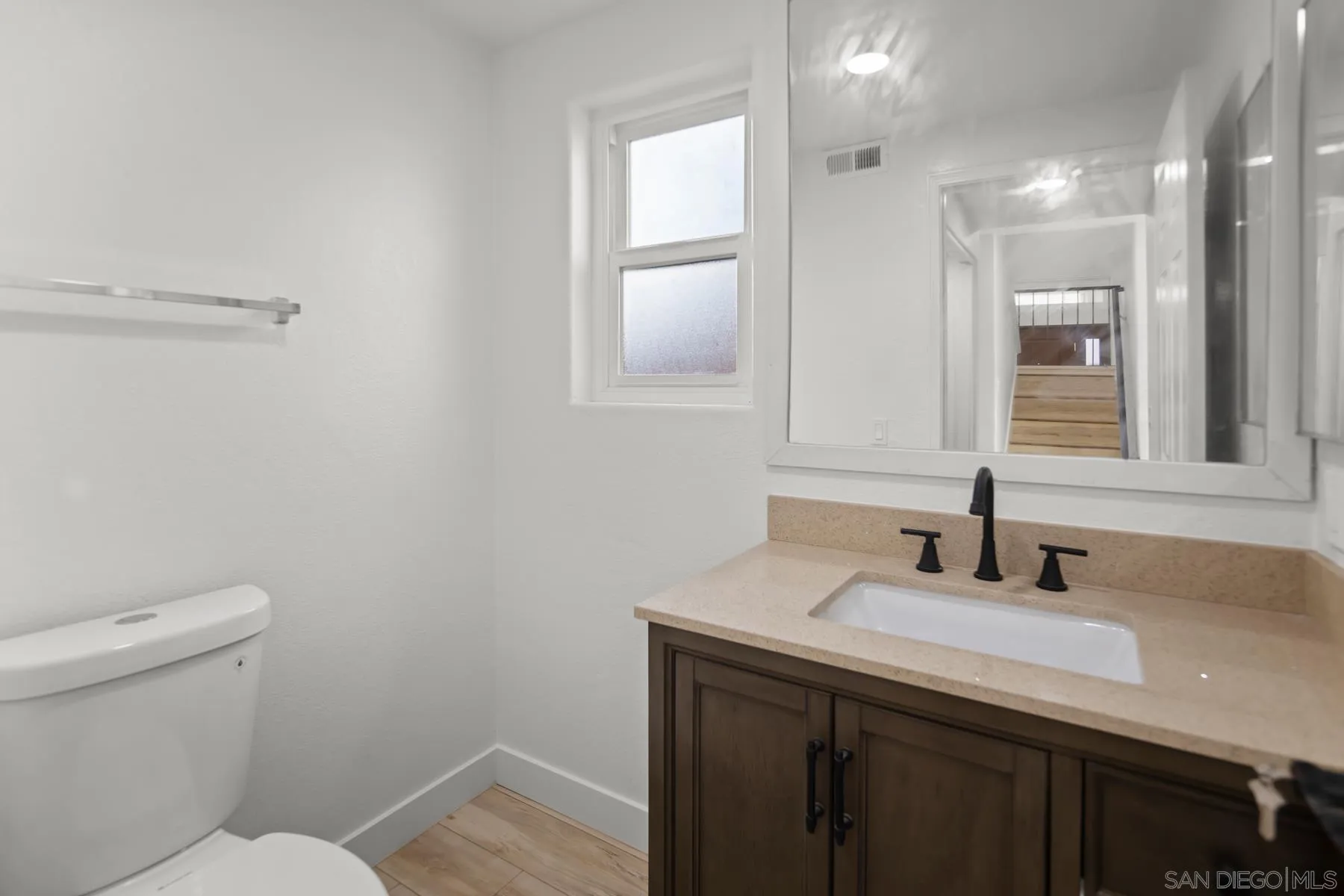 10167 Bluestone Court Spring Valley, CA 91977 - Photo 6 of 49 a bathroom with a sink a toilet and mirror