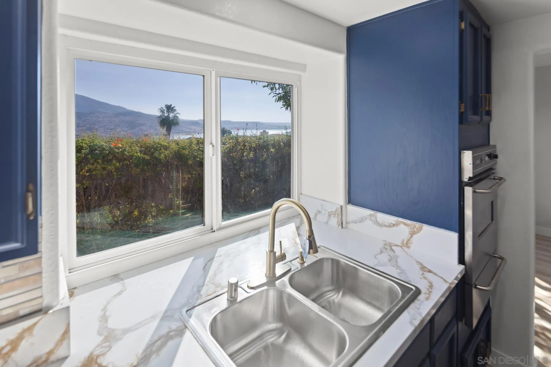 10167 Bluestone Court Spring Valley, CA 91977 - Photo 10 of 49 a bathroom with a sink and a large mirror