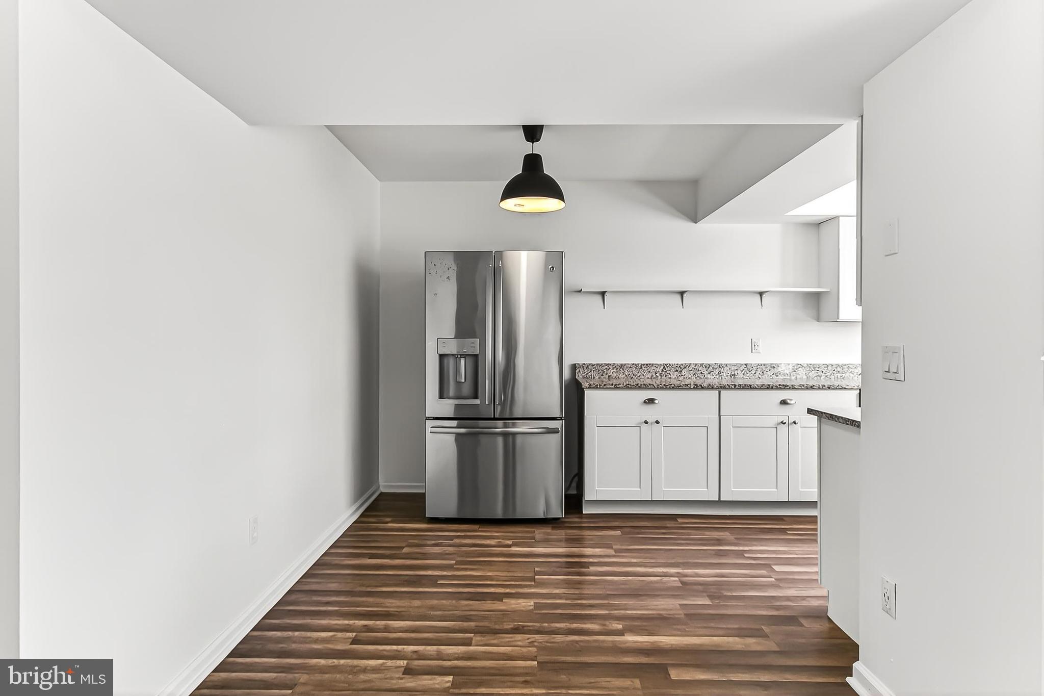 120 Prosperity Avenue Southeast, Unit E Leesburg, VA 20175 - Photo 14 of 34 a kitchen with stainless steel appliances granite countertop a refrigerator and a stove top oven