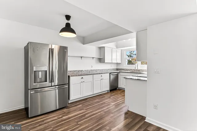 a kitchen with wooden floors and white appliances