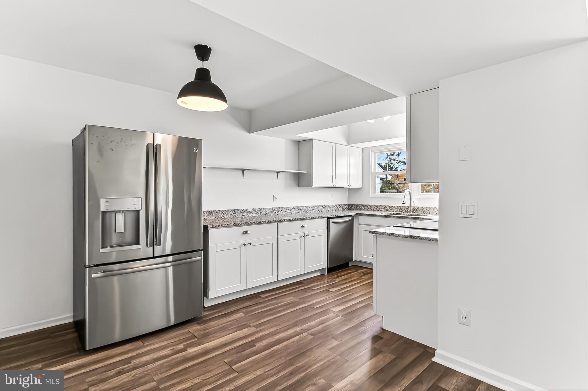 120 Prosperity Avenue Southeast, Unit E Leesburg, VA 20175 - Photo 15 of 34 a kitchen with stainless steel appliances a refrigerator sink and wooden floor