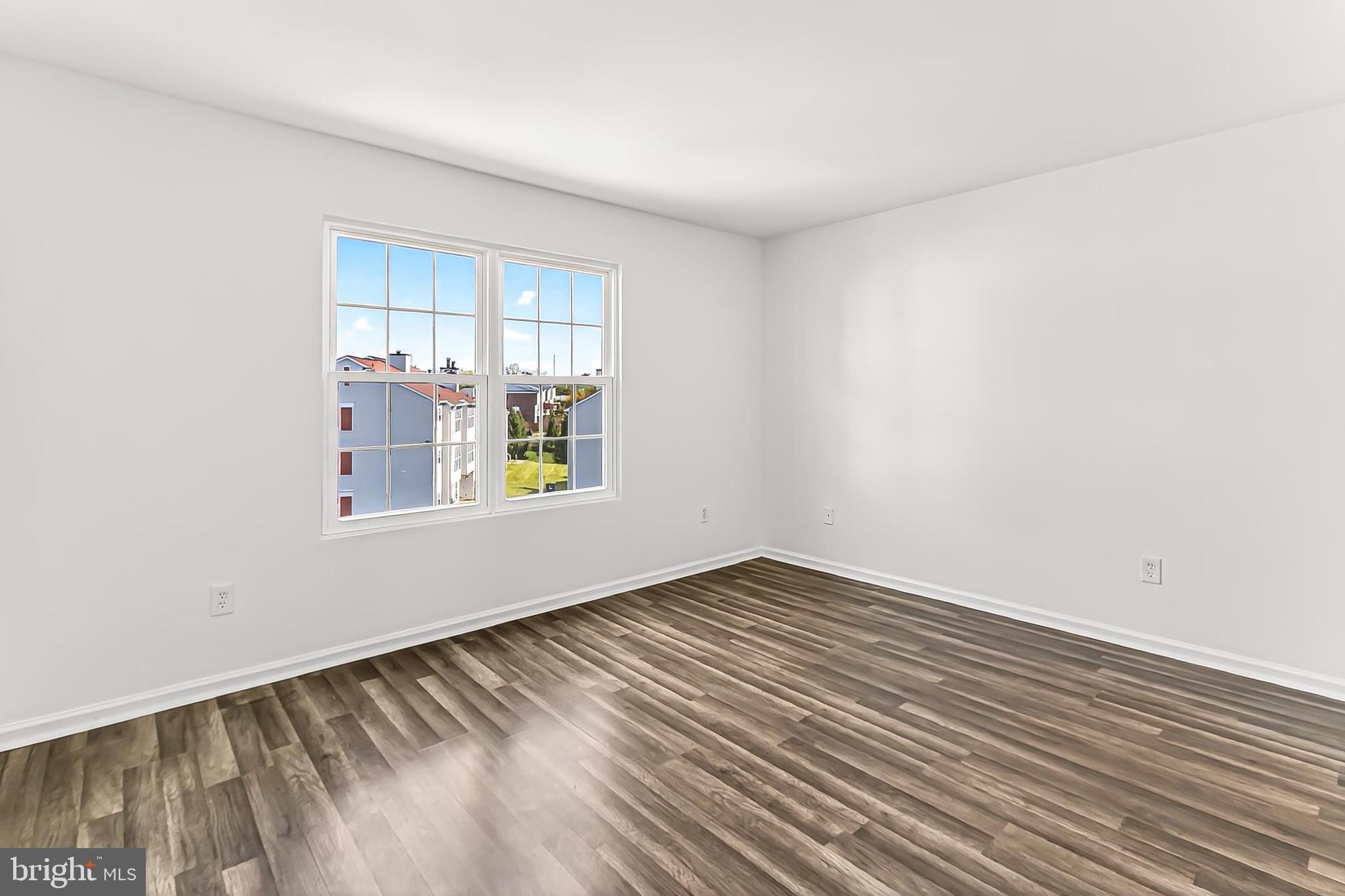 120 Prosperity Avenue Southeast, Unit E Leesburg, VA 20175 - Photo 20 of 34 a view of an empty room with window and wooden floor