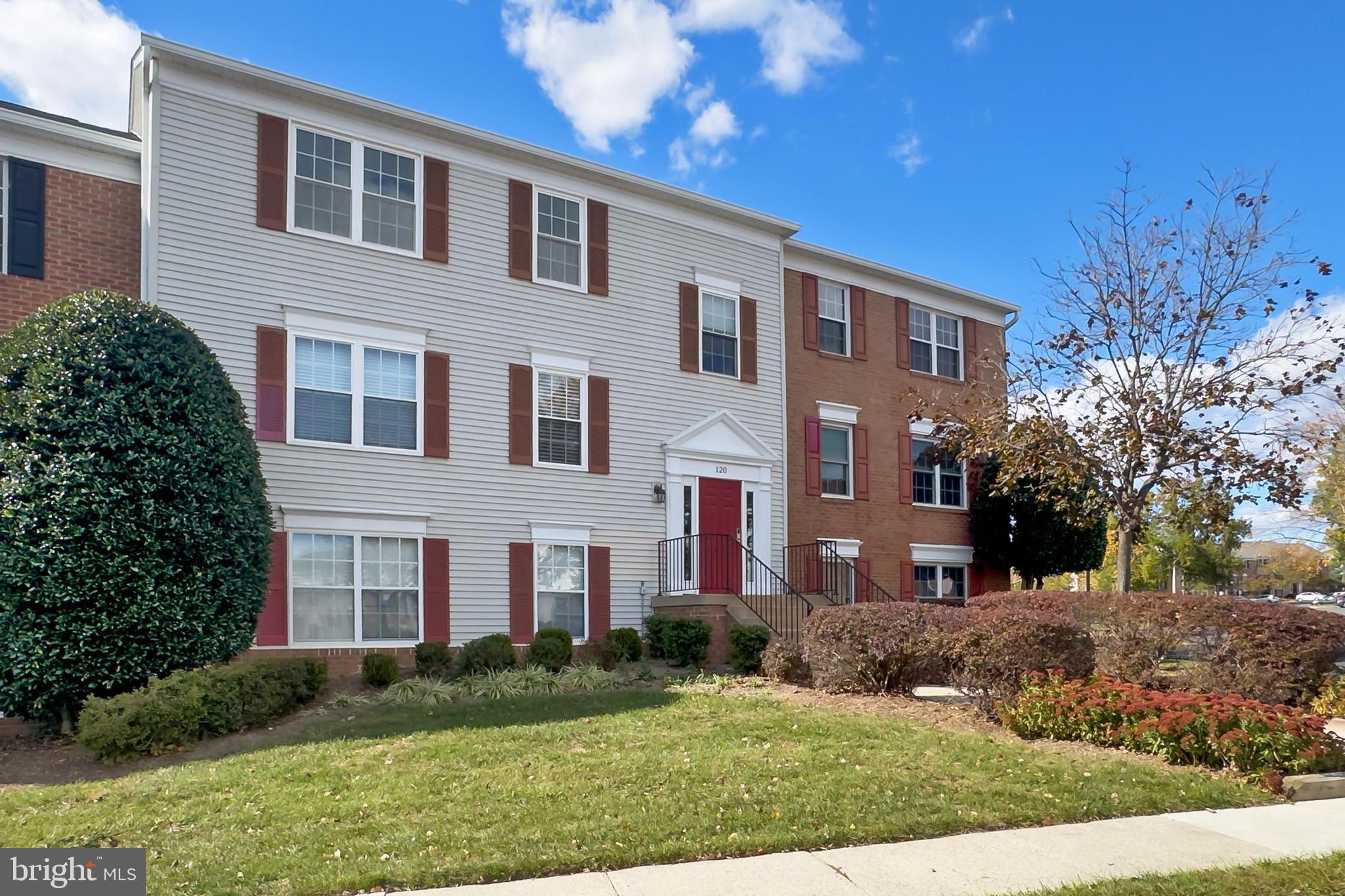 120 Prosperity Avenue Southeast, Unit E Leesburg, VA 20175 - Photo 2 of 34 a view of a brick building next to a yard