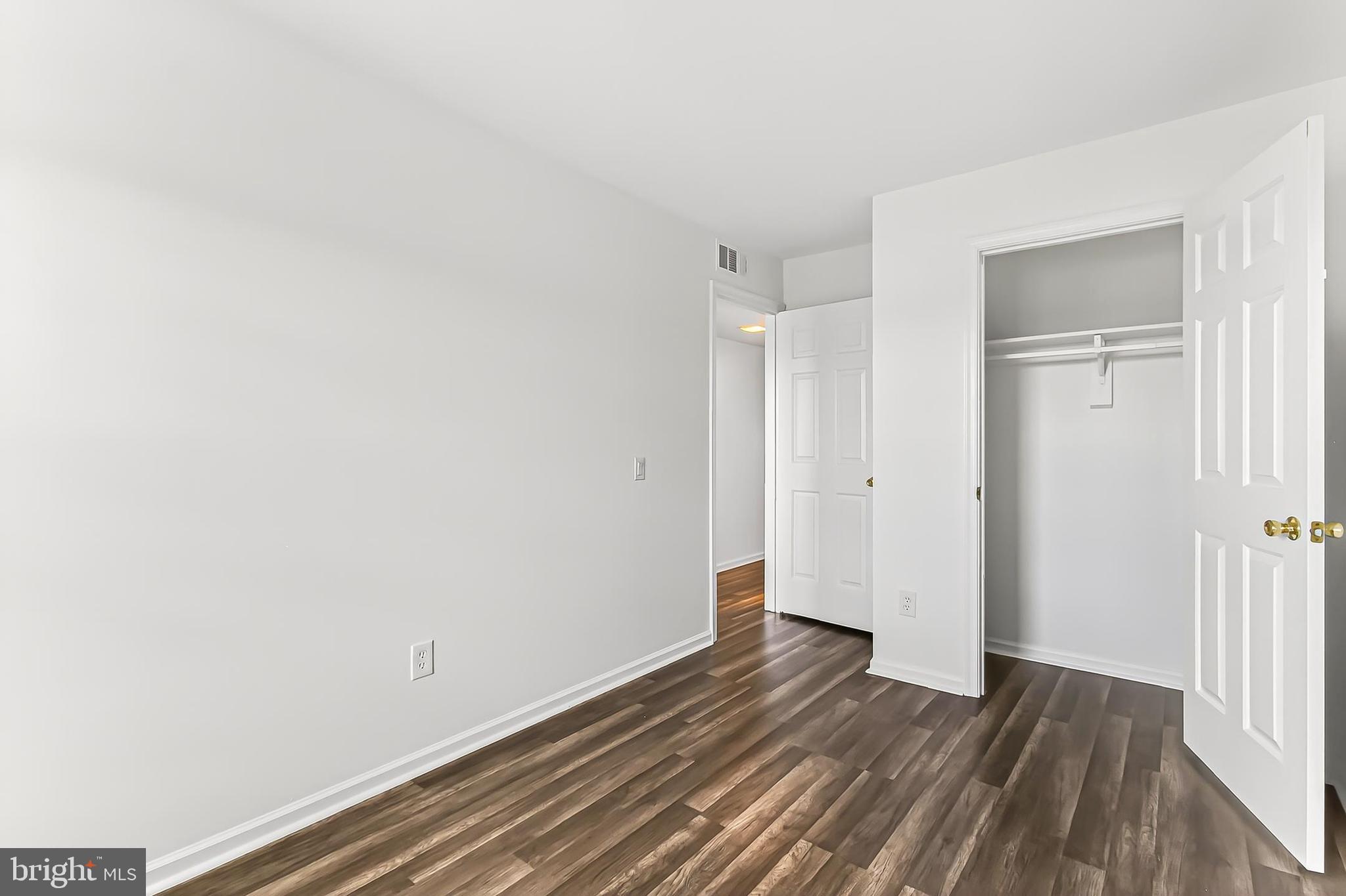 120 Prosperity Avenue Southeast, Unit E Leesburg, VA 20175 - Photo 25 of 34 a view of a room with wooden floor and white doors