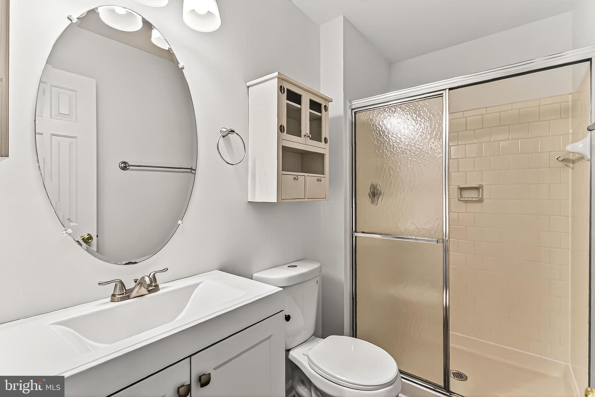 120 Prosperity Avenue Southeast, Unit E Leesburg, VA 20175 - Photo 26 of 34 a bathroom with a sink a toilet and a mirror