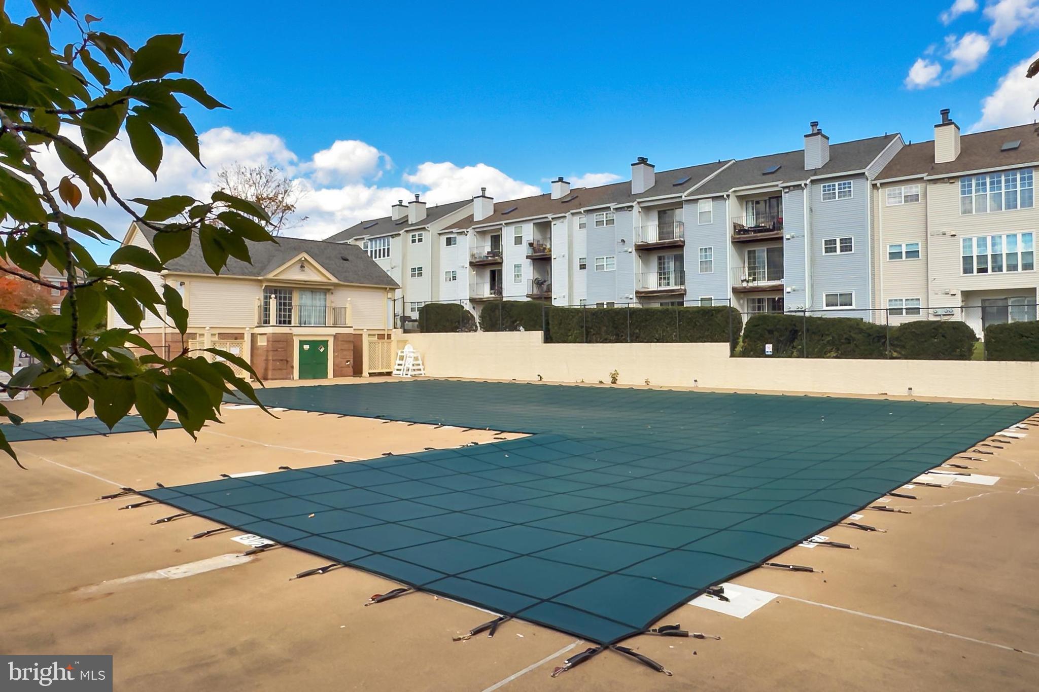 120 Prosperity Avenue Southeast, Unit E Leesburg, VA 20175 - Photo 31 of 34 a view of a white building with a yard