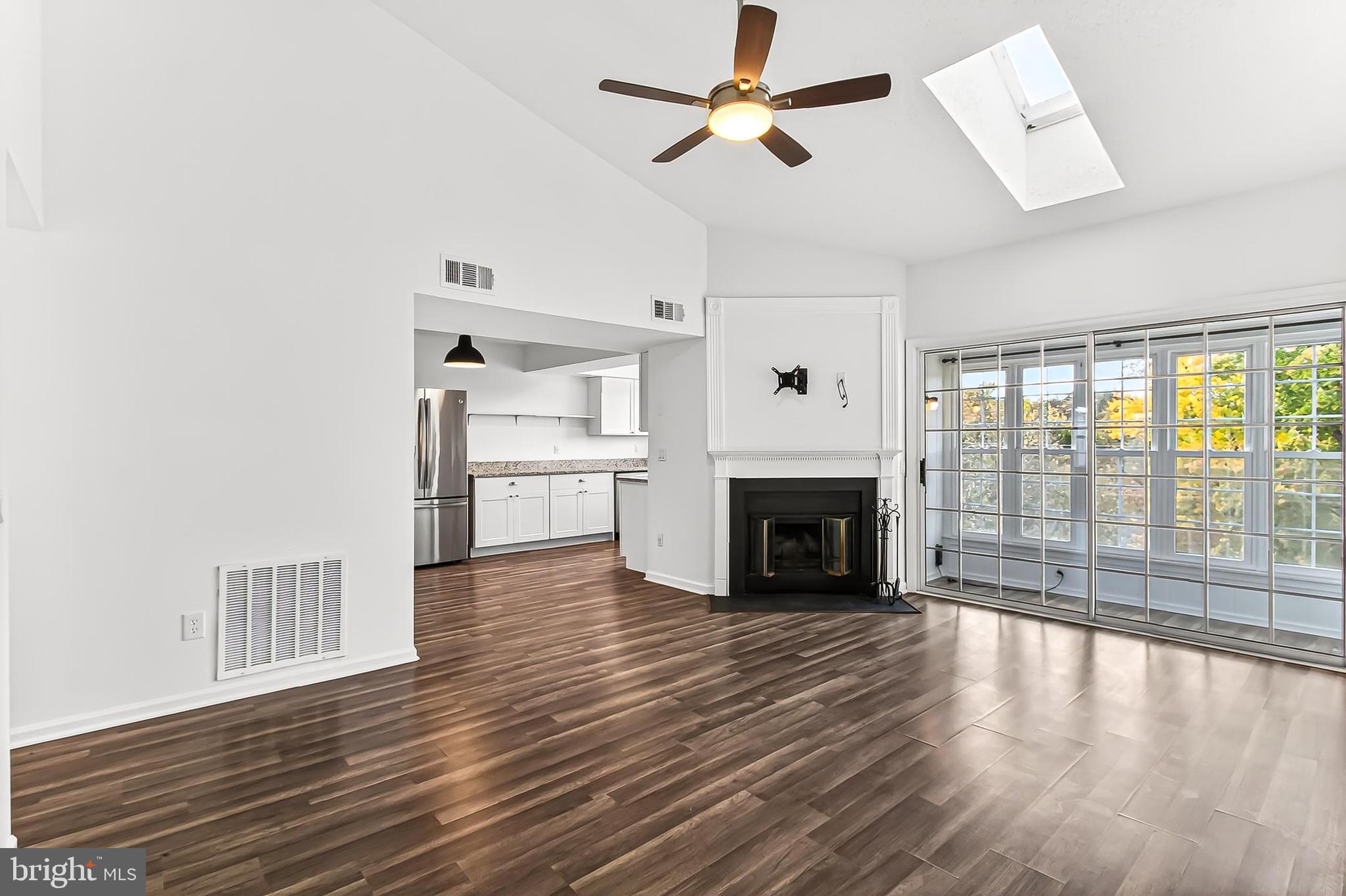 120 Prosperity Avenue Southeast, Unit E Leesburg, VA 20175 - Photo 5 of 34 a view of a livingroom with wooden floor a fireplace and windows