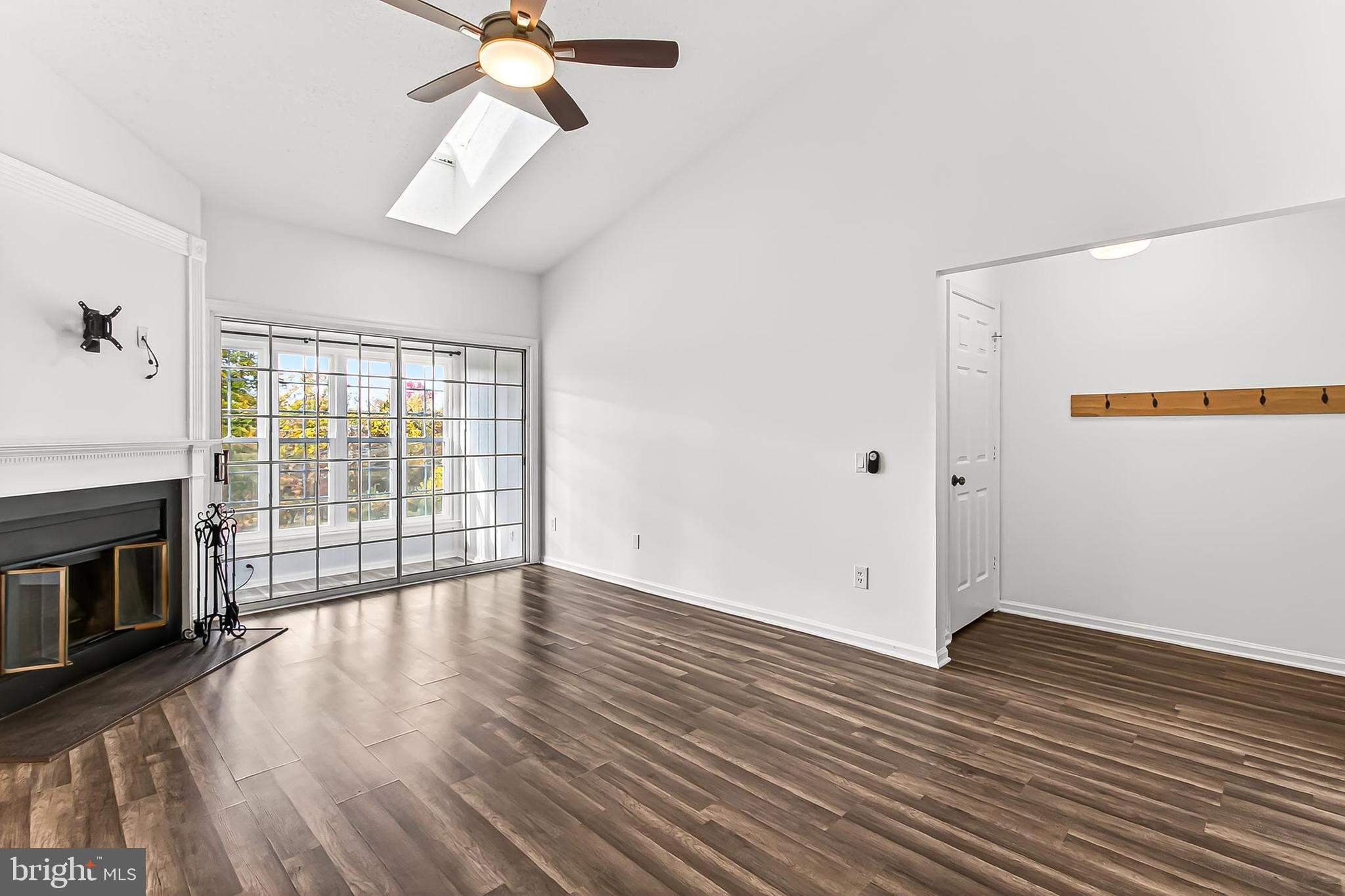 120 Prosperity Avenue Southeast, Unit E Leesburg, VA 20175 - Photo 7 of 34 wooden floor in an empty room with a window