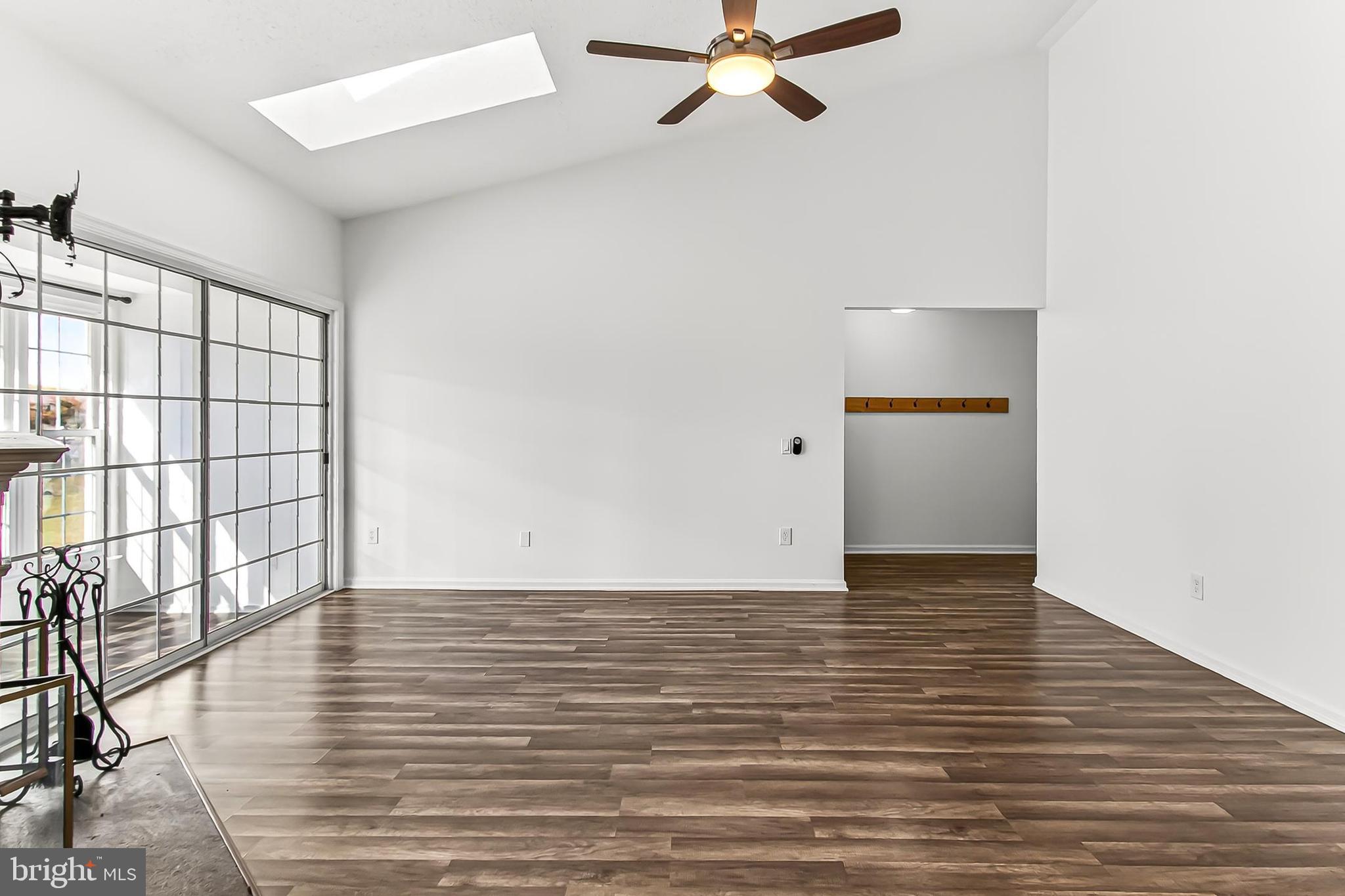 120 Prosperity Avenue Southeast, Unit E Leesburg, VA 20175 - Photo 8 of 34 a view of an empty room with wooden floor and a window
