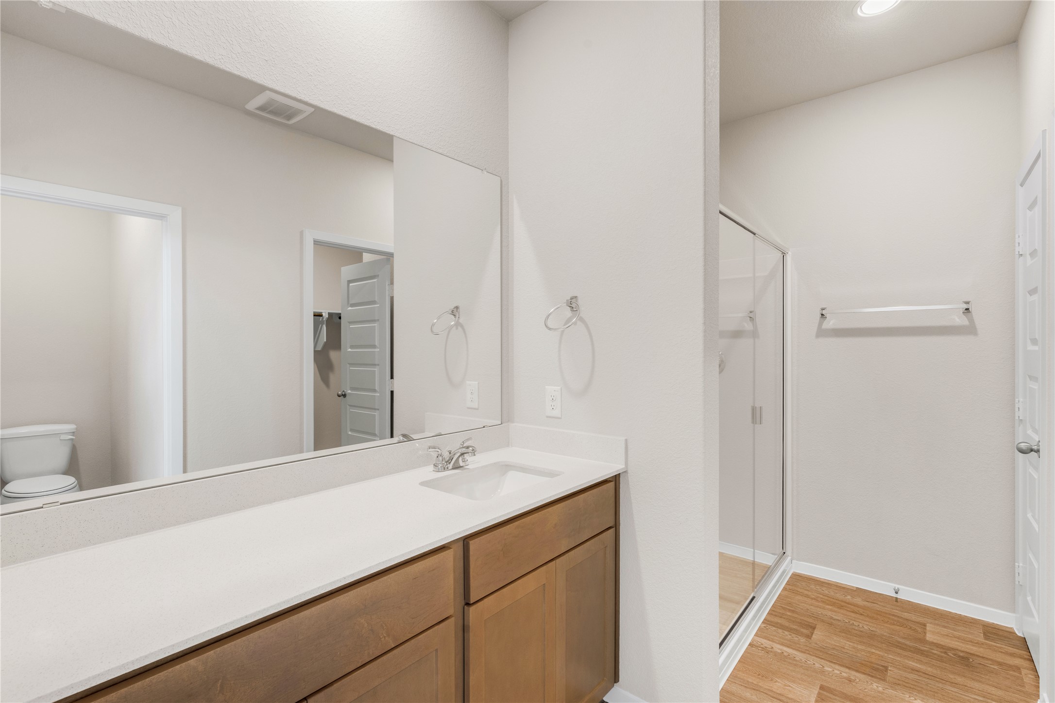 2615 Towy Road Manor, TX 78653 - Photo 14 of 38 Full bath featuring a shower stall, vanity, light wood-style flooring, and recessed lighting