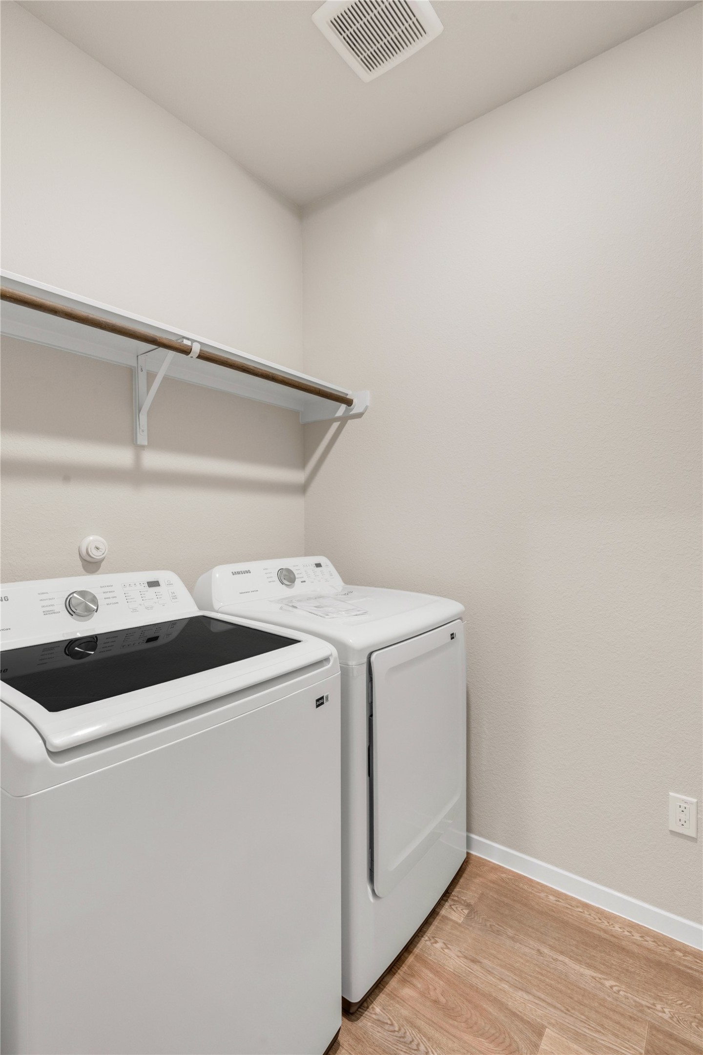 2615 Towy Road Manor, TX 78653 - Photo 18 of 38 Laundry room with light wood finished floors and washer and dryer