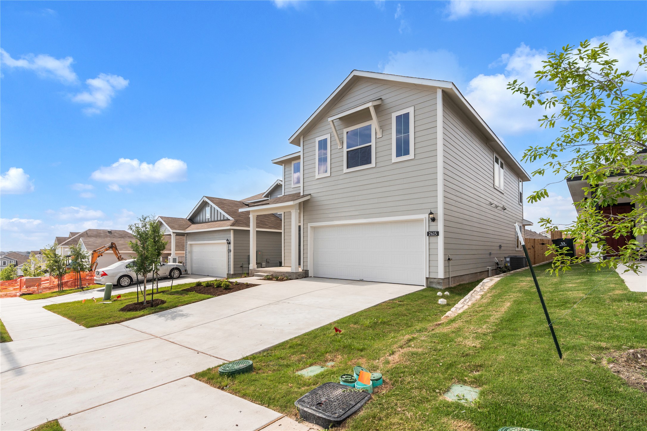 2615 Towy Road Manor, TX 78653 - Photo 3 of 38 Traditional home with a garage, driveway, a front lawn, and a residential view