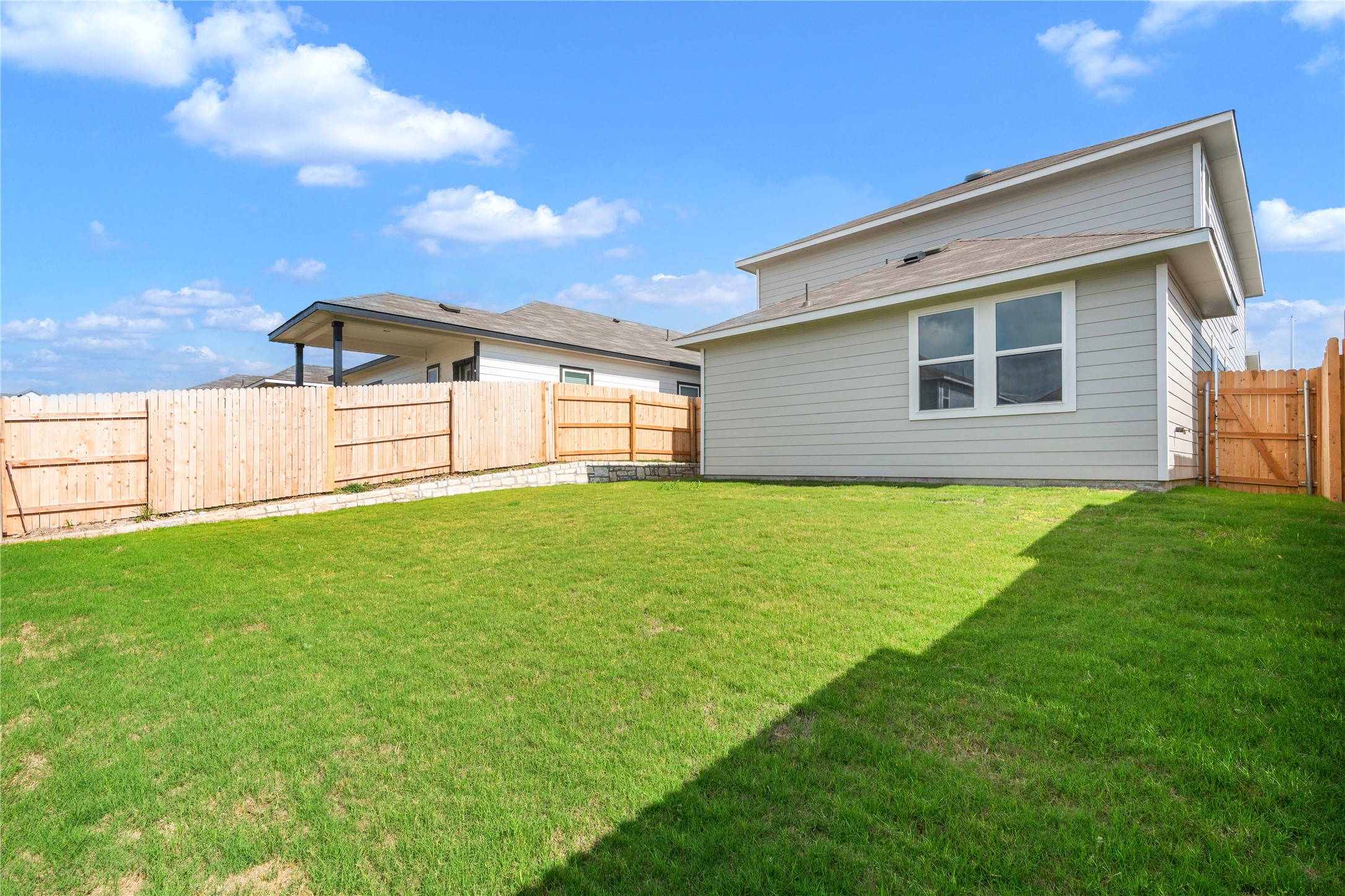 2615 Towy Road Manor, TX 78653 - Photo 33 of 38 Fenced backyard with a gate
