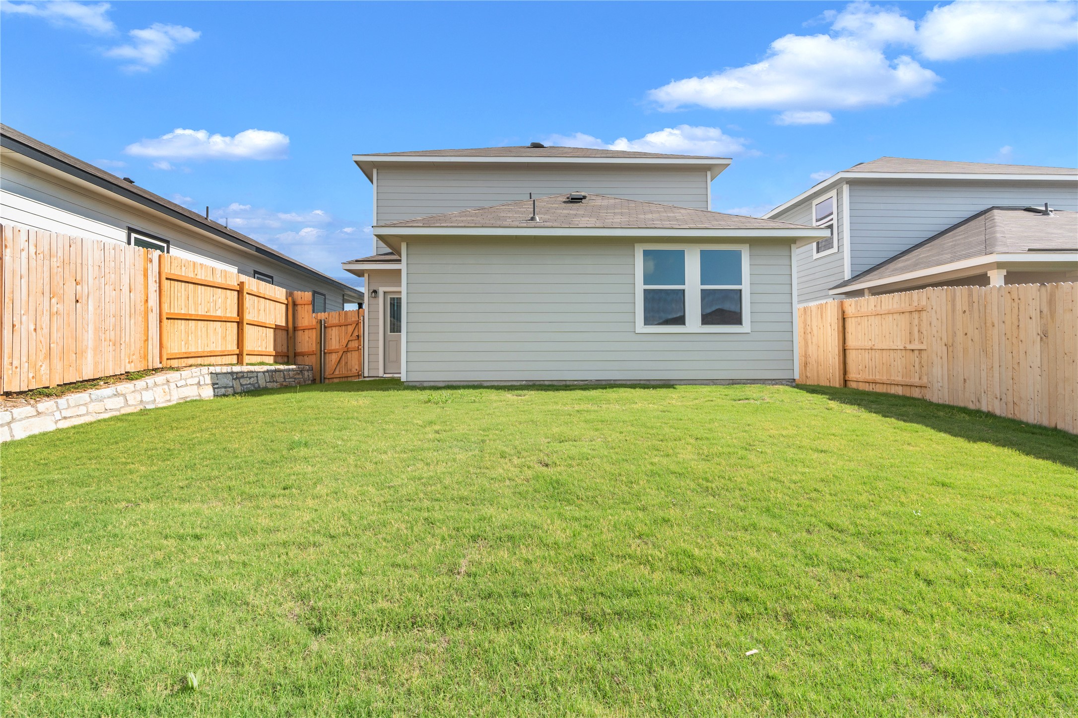 2615 Towy Road Manor, TX 78653 - Photo 34 of 38 Back of property with a fenced backyard and a shingled roof