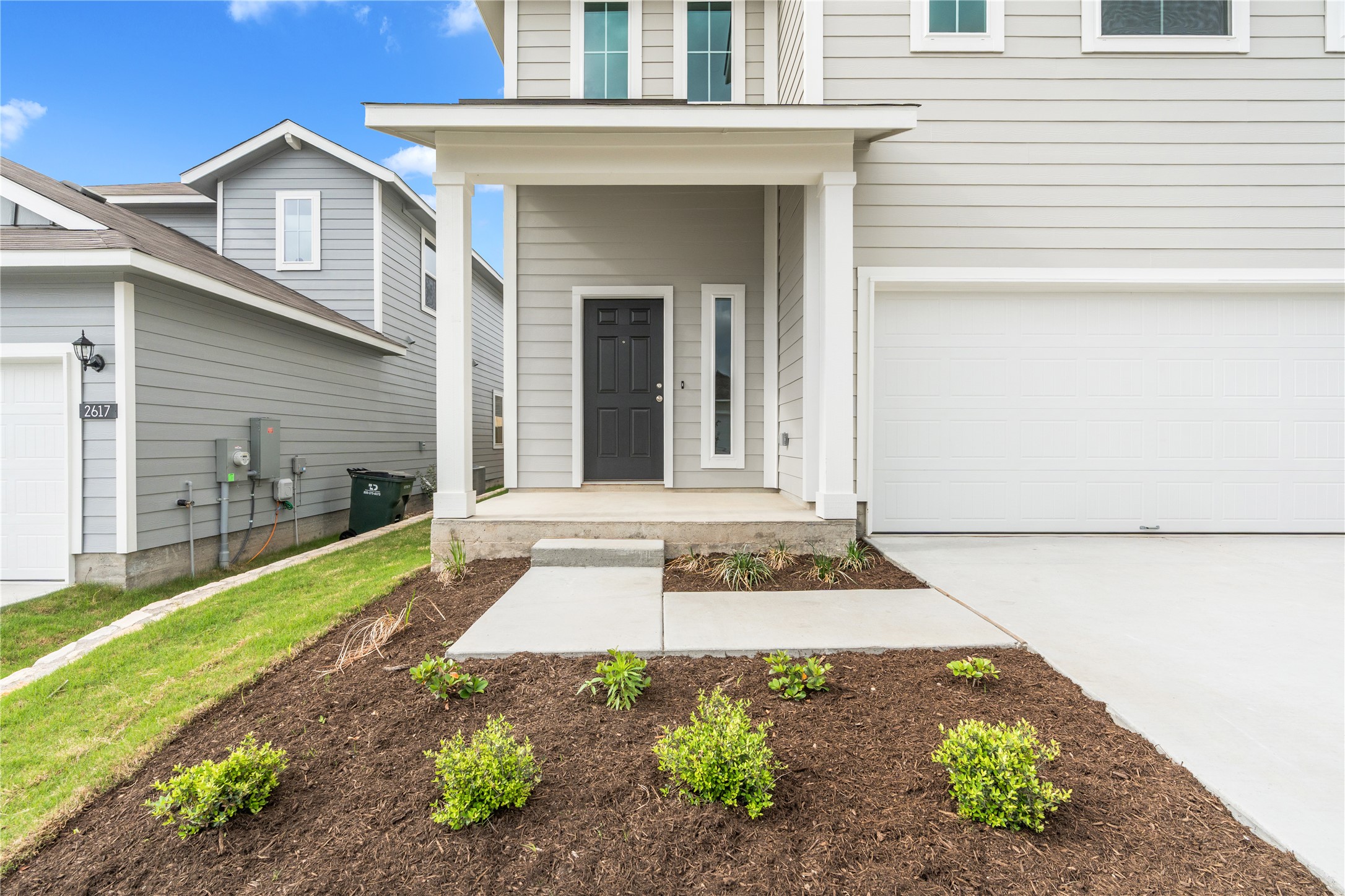 2615 Towy Road Manor, TX 78653 - Photo 4 of 38 View of exterior entry featuring a porch, driveway, and an attached garage