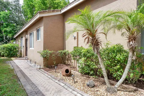 a view of a house with backyard and sitting area