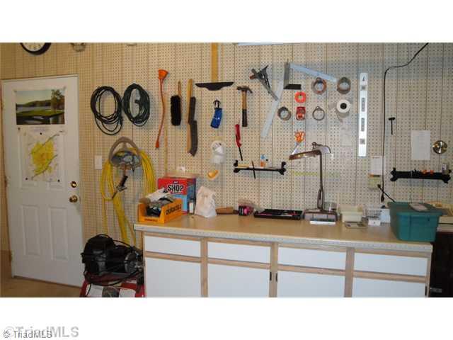 6689 Currieton Drive Oak Ridge, NC 27310 - Photo 10 of 16 Workshop. The pegboard walls are a great way to organize the tools