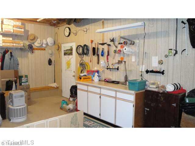 6689 Currieton Drive Oak Ridge, NC 27310 - Photo 11 of 16 Workshop. Just off the garage is this incredible in-home shop for those who like to do it yourself! Room is heated and cooled, but not counted in square footage