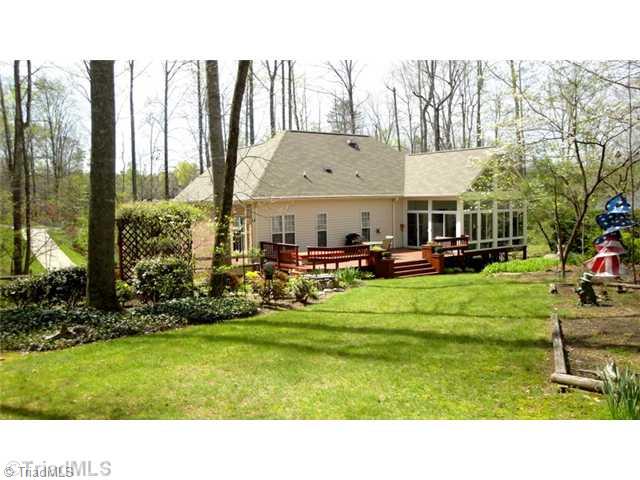 6689 Currieton Drive Oak Ridge, NC 27310 - Photo 15 of 16 Exterior Back. The home has had several updates in recent years, including the roof, sunroom addition, and tankless Rinnai water heater