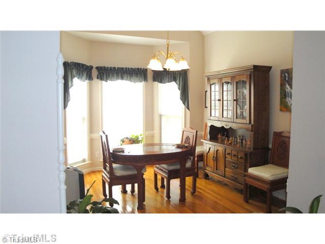 6689 Currieton Drive Oak Ridge, NC 27310 - Photo 3 of 16 Dining Room. The Dining Room has warm hardwoods, vaulted ceiling and bay window overlooking the beautiful grounds