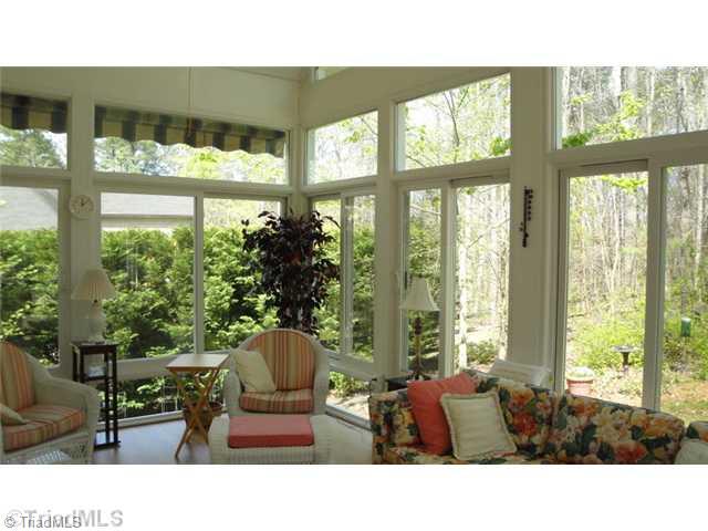 6689 Currieton Drive Oak Ridge, NC 27310 - Photo 6 of 16 Sunroom. The striped awning provides shade from the afternoon sun