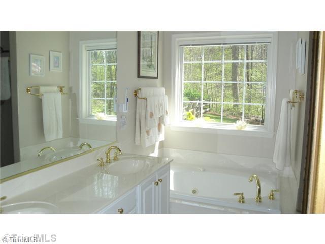 6689 Currieton Drive Oak Ridge, NC 27310 - Photo 8 of 16 Master Bath/Spa. This beautiful Master Bath has a jetted tub, separate shower, water closet and large walk in closet...check out the view!