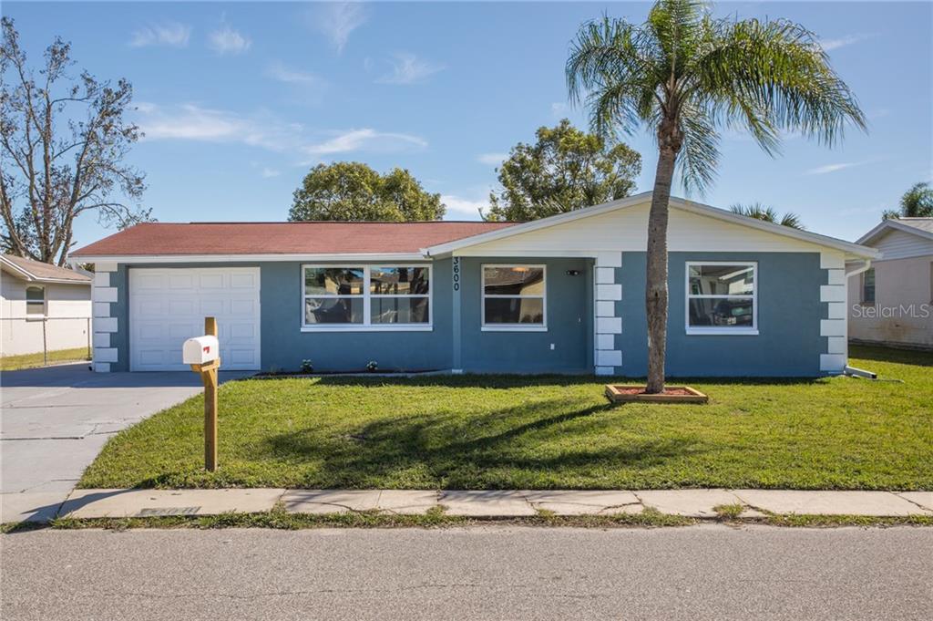 3600 Chauncy Road Holiday, FL 34691 - Photo 1 of 1 a front view of a house with a garden and yard