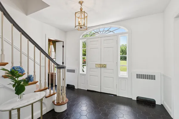 a view of a livingroom with furniture a dinning room and stairs
