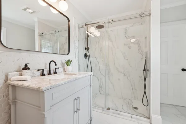 a view of bathroom with bathtub and shower
