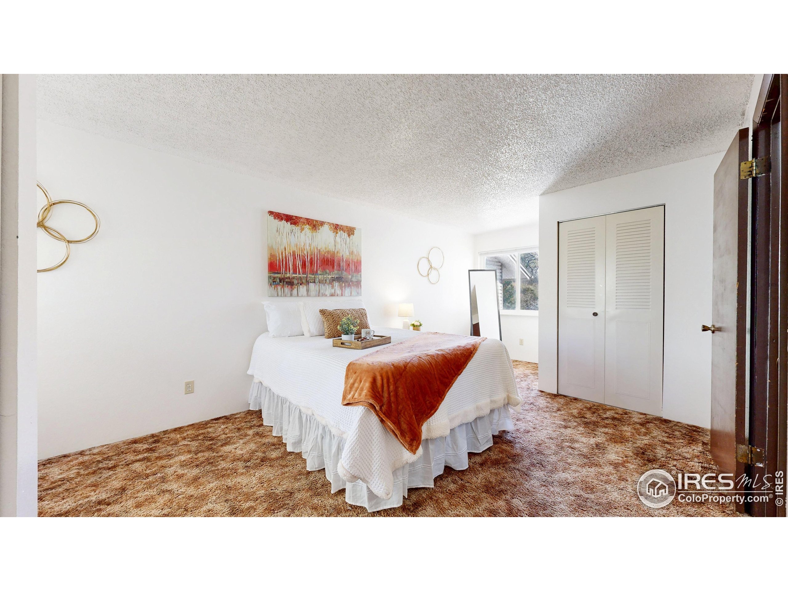 1705 Heatheridge Road, Unit G302 Fort Collins, CO 80526 - Photo 15 of 36 a living room with a bed and a painting on the wall
