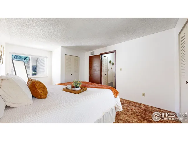 a bedroom with a bed and a lamp