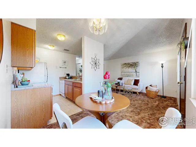a living room with dining table and chairs