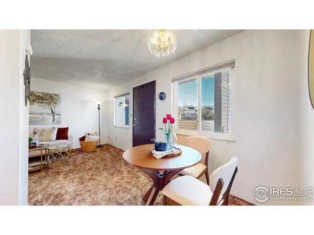 a living room with dining room and wooden floor