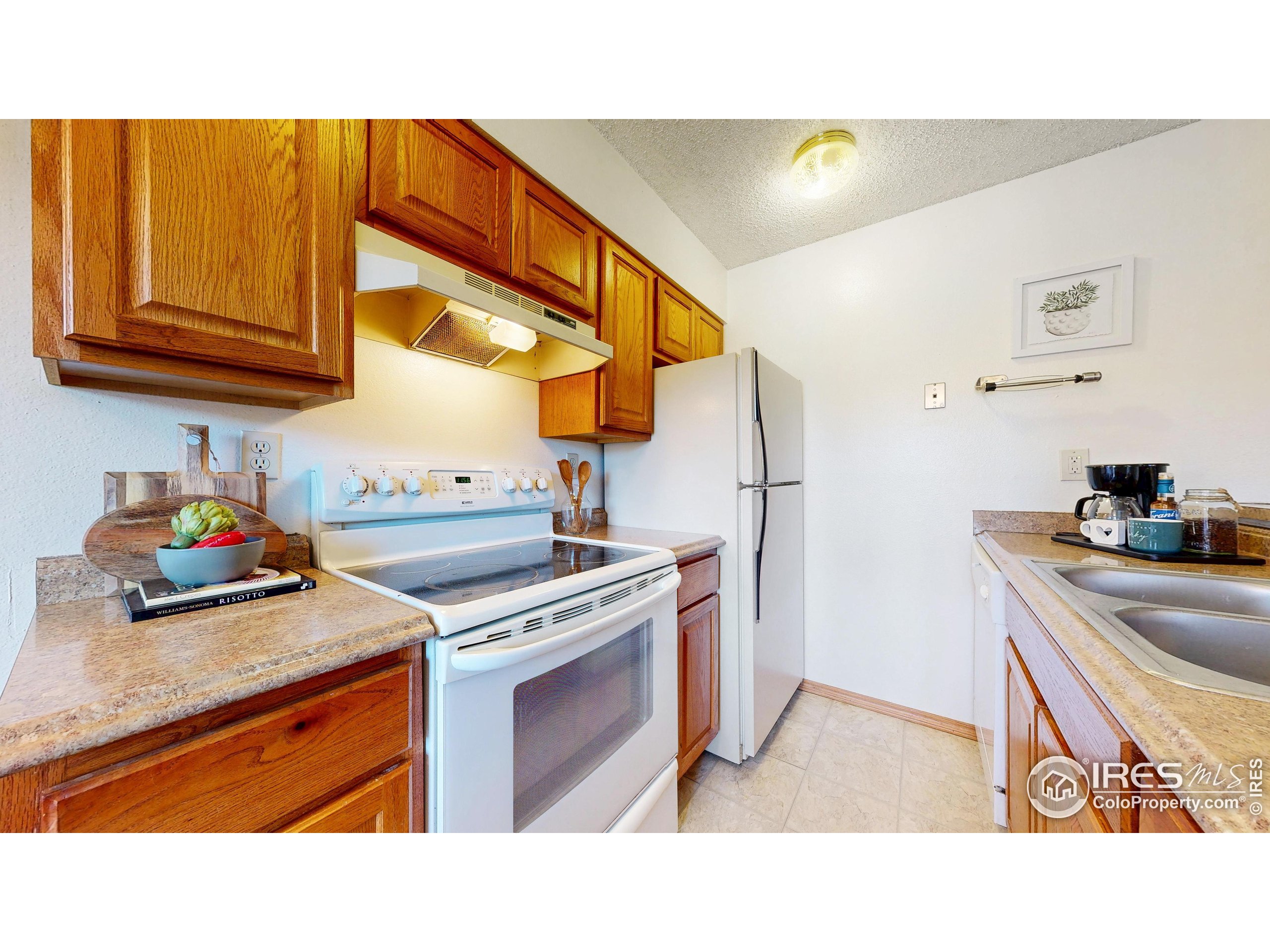 1705 Heatheridge Road, Unit G302 Fort Collins, CO 80526 - Photo 10 of 36 a kitchen with stainless steel appliances granite countertop a stove a sink and a refrigerator