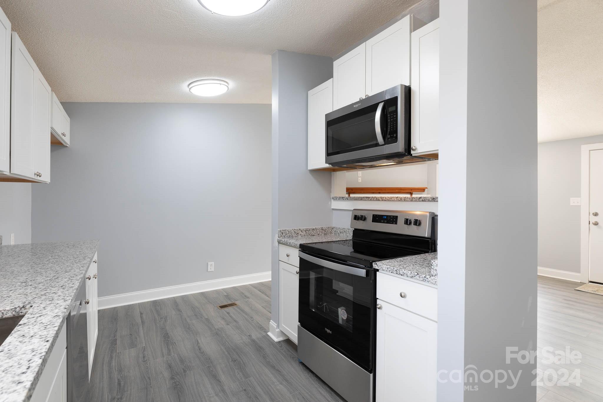154 Brown Neal Road York, SC 29745 - Photo 11 of 24 a kitchen with a stove microwave and sink