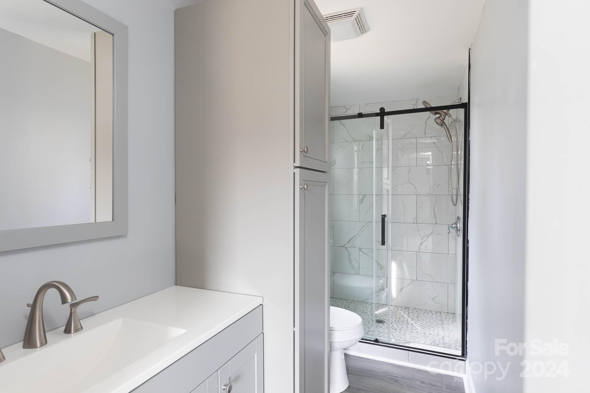 154 Brown Neal Road York, SC 29745 - Photo 14 of 24 a bathroom with a shower sink and mirror