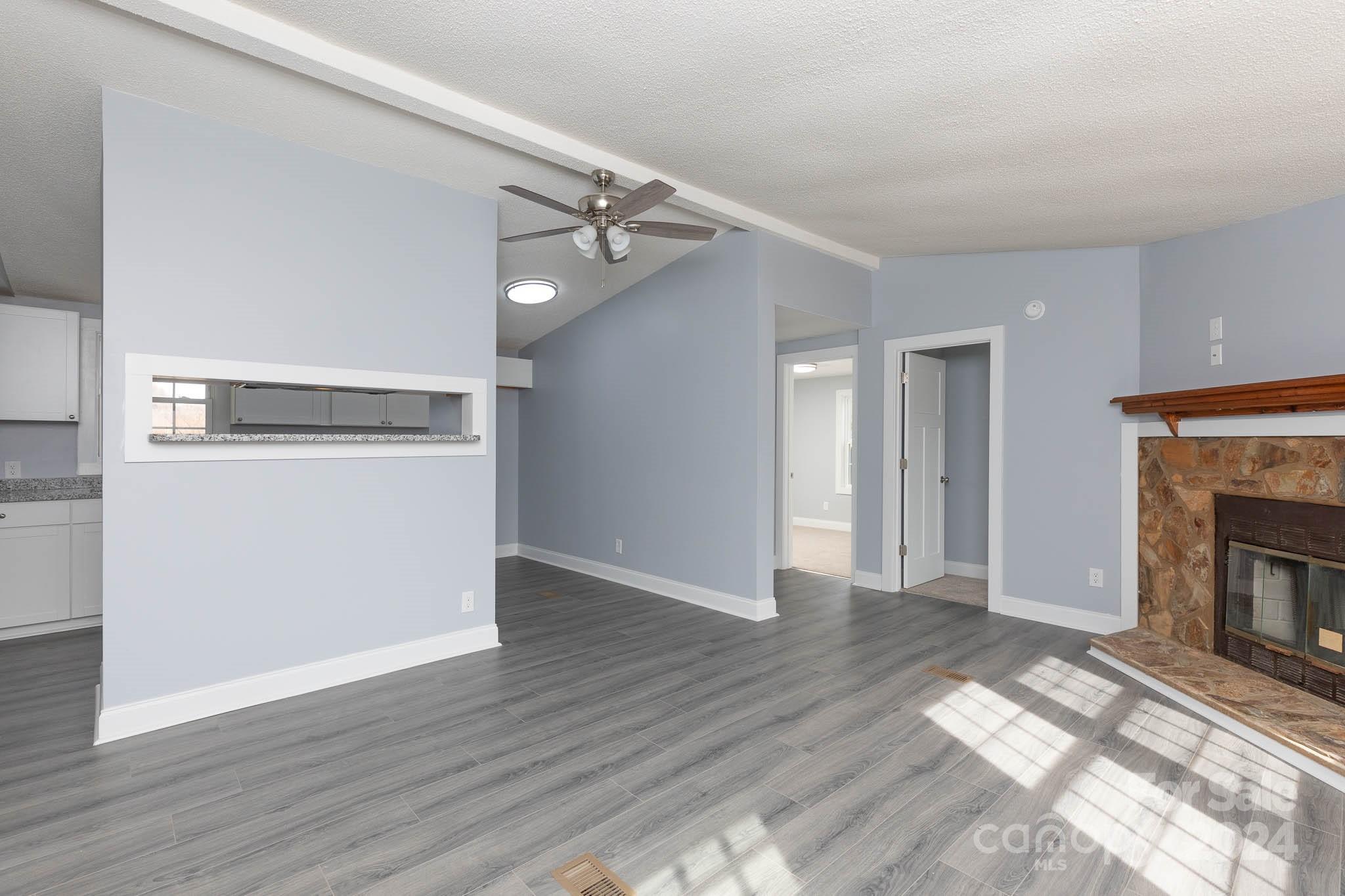 154 Brown Neal Road York, SC 29745 - Photo 18 of 24 a view of a livingroom with wooden floor and a fireplace