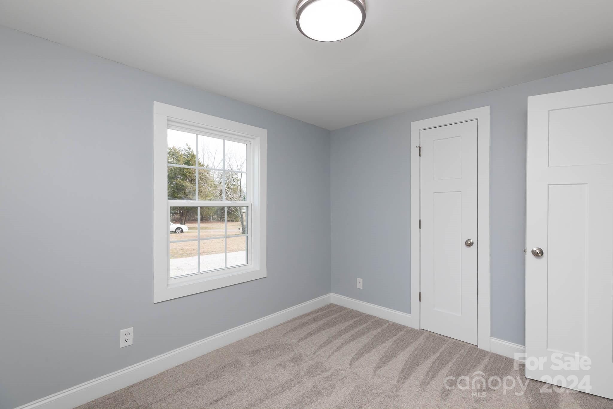 154 Brown Neal Road York, SC 29745 - Photo 21 of 24 a view of an empty room with wooden floor and a window