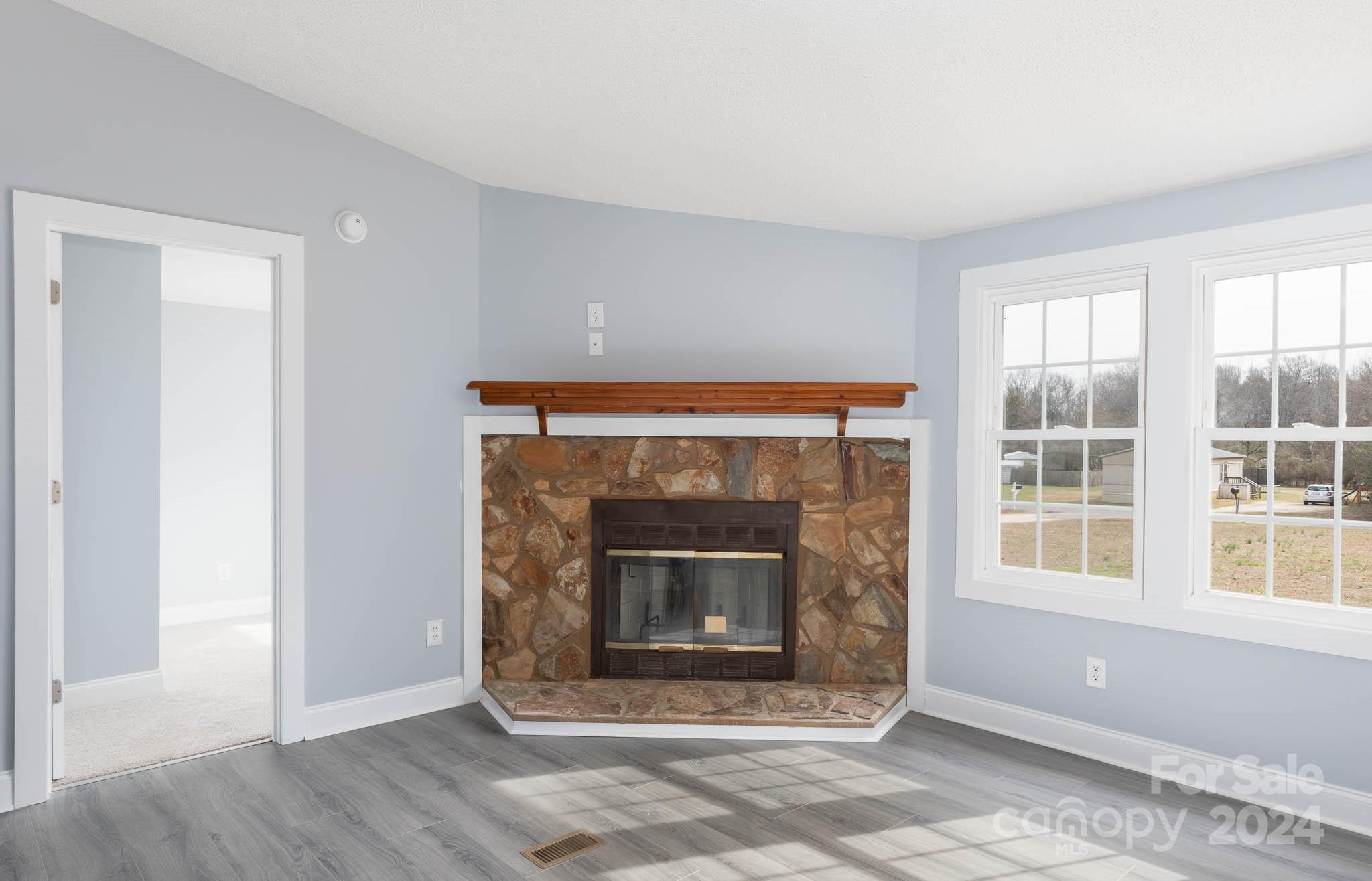 154 Brown Neal Road York, SC 29745 - Photo 3 of 24 a living room with a fireplace and a window