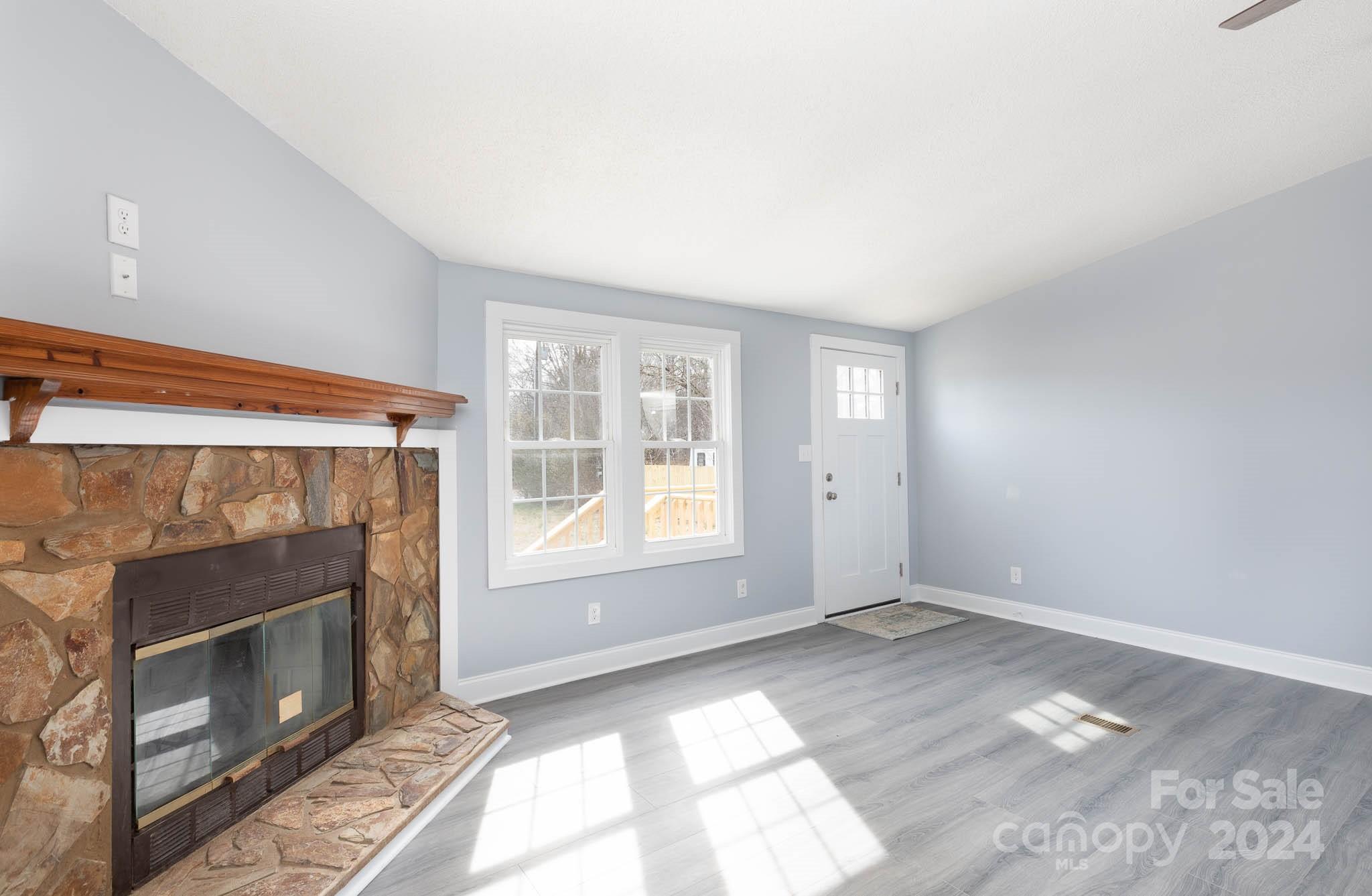 154 Brown Neal Road York, SC 29745 - Photo 4 of 24 a view of empty room with a fireplace and window