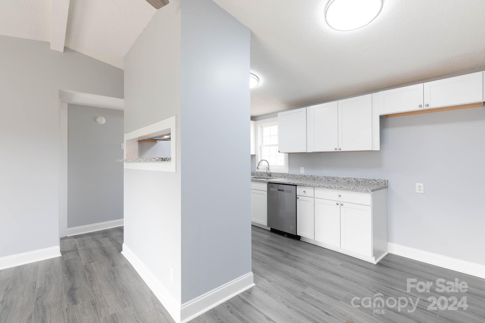 154 Brown Neal Road York, SC 29745 - Photo 5 of 24 a kitchen with granite countertop white cabinets and white appliances