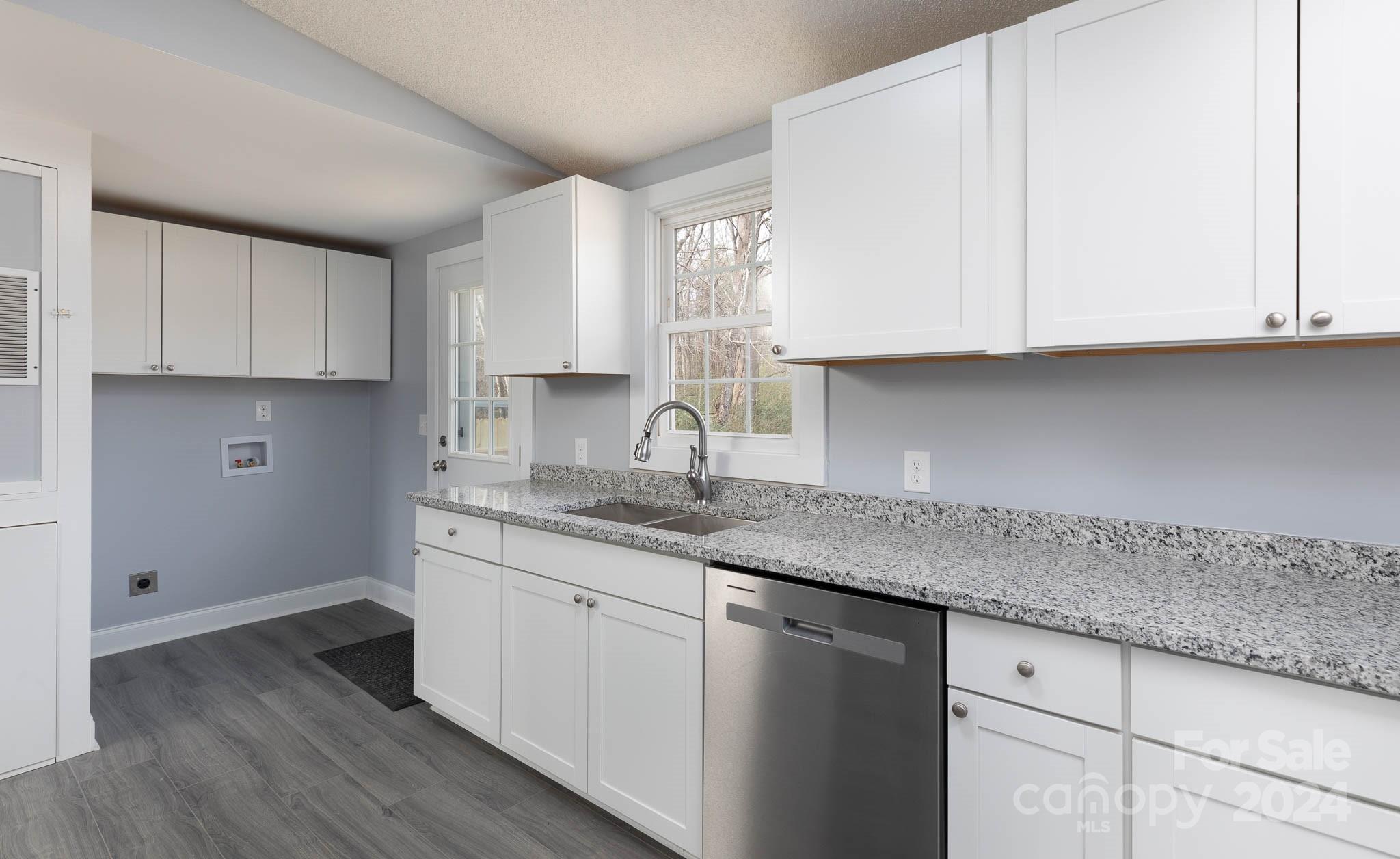 154 Brown Neal Road York, SC 29745 - Photo 6 of 24 a kitchen with granite countertop white cabinets and a sink