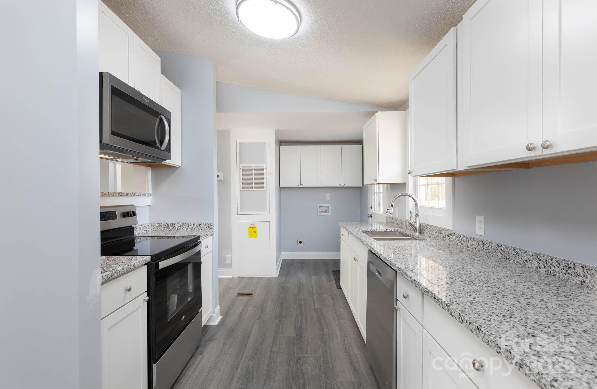 154 Brown Neal Road York, SC 29745 - Photo 7 of 24 a kitchen with a sink stove top oven and cabinets