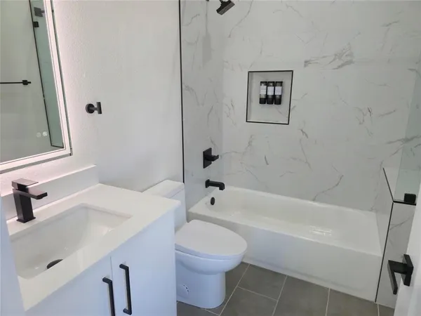 a bathroom with a sink a toilet and a bathtub
