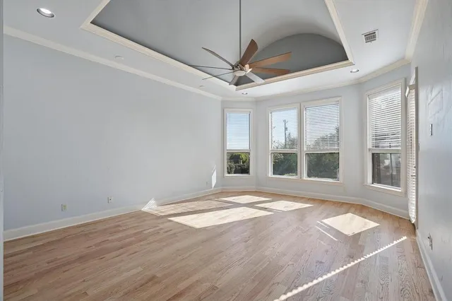 a bedroom with a bed couches and a large window