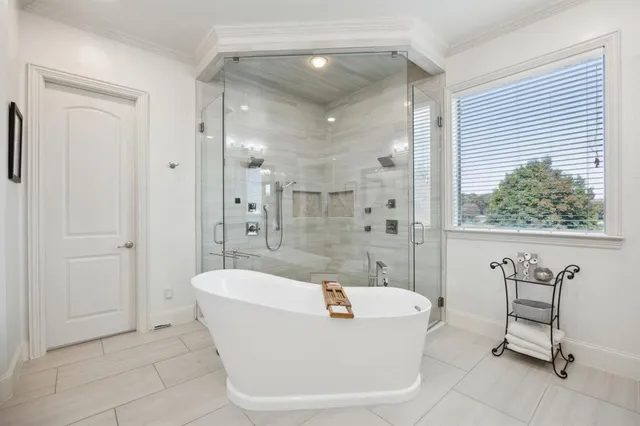 a spacious bathroom with a granite countertop sink a toilet a mirror and shower